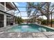 Inviting screened pool with patio and water view at 13477 Irwin Dr, Port Charlotte, FL 33953