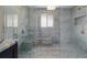 Large walk-in shower with blue marble tile and built-in seat at 13477 Irwin Dr, Port Charlotte, FL 33953
