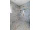 Spacious shower with blue marble tile and multiple shower heads at 13477 Irwin Dr, Port Charlotte, FL 33953