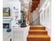 Elegant spiral staircase with wooden steps and glass railing at 13477 Irwin Dr, Port Charlotte, FL 33953