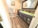 Modern bathroom with double vanity and wood-look floors at 1400 Tarpon Woods Blvd # H6, Palm Harbor, FL 34685