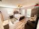 Bright bedroom with wood-look floors, and a ceiling fan at 1400 Tarpon Woods Blvd # H6, Palm Harbor, FL 34685