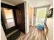 Condo entryway with door, storage and wood-look floors at 1400 Tarpon Woods Blvd # H6, Palm Harbor, FL 34685