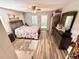Bright bedroom with a floral bedspread and plenty of closet space at 1400 Tarpon Woods Blvd # H6, Palm Harbor, FL 34685