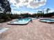 Community pool and spa with patio and lounge chairs at 1400 Tarpon Woods Blvd # H6, Palm Harbor, FL 34685