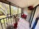 Relaxing screened balcony with wooded views and outdoor seating at 1400 Tarpon Woods Blvd # H6, Palm Harbor, FL 34685