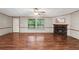 Living room with fireplace, laminate flooring, and large window at 14927 Balough Rd, Odessa, FL 33556