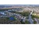 Aerial view of a residential community with houses, lakes, and roads at 1542 Deerbourne Dr, Wesley Chapel, FL 33543