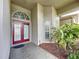 Front entrance with double doors and tropical plants at 1542 Deerbourne Dr, Wesley Chapel, FL 33543