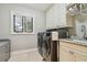 Bright laundry room with washer, dryer, and cabinets at 16403 Zurraquin De Avila, Tampa, FL 33613