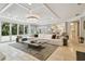 Spacious living room with large sectional sofa, coffee table, and access to pool at 16403 Zurraquin De Avila, Tampa, FL 33613
