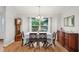 Bright dining room features a wood table, chairs, and hardwood floors at 1662 Spottswood Cir, Palm Harbor, FL 34683