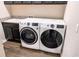 Well-equipped laundry room with a washer, dryer, utility sink and modern cabinets at 19427 Redwood Point Dr, Tampa, FL 33647