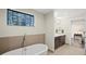 Relaxing bathroom with soaking tub, stained glass window, and modern fixtures at 199 Dali Blvd # 407, St Petersburg, FL 33701