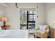 Serene bedroom with large window, comfortable armchair, and hardwood floors at 199 Dali Blvd # 407, St Petersburg, FL 33701