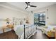 Cozy bedroom with large window, ceiling fan, and hardwood floors at 199 Dali Blvd # 407, St Petersburg, FL 33701