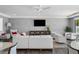 Relaxing community room furnished with sofas, armchairs, and a large TV at 199 Dali Blvd # 407, St Petersburg, FL 33701