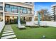 Relaxing courtyard with artificial turf, modern furniture, and umbrellas for shade at 199 Dali Blvd # 407, St Petersburg, FL 33701