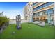 Private courtyard with artificial turf, modern sculptures, and comfortable seating at 199 Dali Blvd # 407, St Petersburg, FL 33701