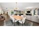 Open concept dining room with large wood table and modern chandelier at 199 Dali Blvd # 407, St Petersburg, FL 33701