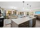 Modern kitchen with island, stainless steel appliances, and white quartz counters at 199 Dali Blvd # 407, St Petersburg, FL 33701