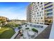 Outdoor entertaining area with a grill, seating, and a view of the pool at 199 Dali Blvd # 407, St Petersburg, FL 33701