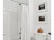Bathroom with white tile, shower/tub combo, and a wicker basket at 21428 Darter Rd, Land O Lakes, FL 34638