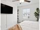 Bedroom with a queen-size bed and a large TV at 21428 Darter Rd, Land O Lakes, FL 34638