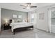 Spacious bedroom with king bed, grey carpet, and sage green accent wall at 21428 Darter Rd, Land O Lakes, FL 34638