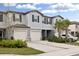 Two-story townhome with attached garage and landscaping at 21428 Darter Rd, Land O Lakes, FL 34638