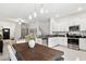 Modern kitchen features stainless steel appliances and an island with seating at 21428 Darter Rd, Land O Lakes, FL 34638