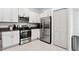Modern kitchen with stainless steel appliances and white cabinets at 21428 Darter Rd, Land O Lakes, FL 34638