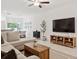 Open living room with L-shaped sofa and large TV at 21428 Darter Rd, Land O Lakes, FL 34638