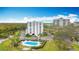 Aerial view showing condo building, pool, and parking at 220 Belleview Blvd # 101, Belleair, FL 33756