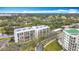 Condo building aerial view, highlighting its location near a lake and golf course at 220 Belleview Blvd # 101, Belleair, FL 33756
