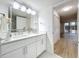 Modern bathroom with double vanity, marble accents, and a view of the living area at 220 Belleview Blvd # 101, Belleair, FL 33756