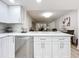 White kitchen cabinets, quartz countertops, open to dining area at 220 Belleview Blvd # 101, Belleair, FL 33756