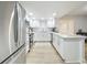 Modern white kitchen with stainless steel appliances and quartz countertops at 220 Belleview Blvd # 101, Belleair, FL 33756