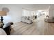 Bright living room with hardwood floors and open concept kitchen at 220 Belleview Blvd # 101, Belleair, FL 33756