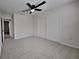 Spacious bedroom with ceiling fan and access to hallway at 2503 Brucken Rd, Brandon, FL 33511