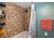 Bathroom with stone shower surround and coral decor at 2621 Cove Cay Dr # 205, Clearwater, FL 33760