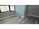 Bright bedroom featuring durable gray wood-look flooring, a large window and neutral paint at 2621 Cove Cay Dr # 205, Clearwater, FL 33760