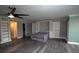 Open concept bedroom features durable wood-look flooring, ceiling fan and built-in shelving at 2621 Cove Cay Dr # 205, Clearwater, FL 33760