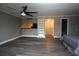 Open concept bedroom featuring durable wood-look flooring, ceiling fan, kitchenette and en-suite at 2621 Cove Cay Dr # 205, Clearwater, FL 33760