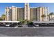 High-rise building with covered parking and landscaping at 2621 Cove Cay Dr # 205, Clearwater, FL 33760