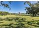 Golf course view with building in the background at 2621 Cove Cay Dr # 205, Clearwater, FL 33760