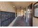 Condominium hallway with mailboxes, elevator, and bench at 2621 Cove Cay Dr # 205, Clearwater, FL 33760