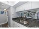Kitchen with granite countertops, double sink, and view to living area at 2621 Cove Cay Dr # 205, Clearwater, FL 33760