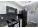 Updated kitchen with black appliances and granite countertops at 2621 Cove Cay Dr # 205, Clearwater, FL 33760