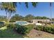 Community pool and relaxing patio area with lush landscaping at 2621 Cove Cay Dr # 205, Clearwater, FL 33760
